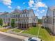 Charming townhome showcasing a manicured front yard, white picket fence and lovely brick and siding elevation at 630 Brashy St, Woodstock, GA 30188