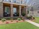 Inviting front porch with rocking chairs, brick columns, and a well-maintained garden at 630 Brashy St, Woodstock, GA 30188