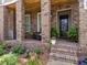 Inviting front porch with rocking chairs, brick columns, and a well-maintained garden at 630 Brashy St, Woodstock, GA 30188