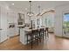 Gourmet kitchen boasts an island with seating, modern appliances, and hardwood floors at 630 Brashy St, Woodstock, GA 30188