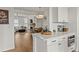 Modern kitchen boasts white cabinets, a center island, and views of the living room at 630 Brashy St, Woodstock, GA 30188