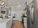 Bright kitchen featuring a stainless steel refrigerator and a spacious quartz countertop at 630 Brashy St, Woodstock, GA 30188