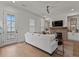 Bright living room featuring a fireplace, white sofa, and a door leading outside at 630 Brashy St, Woodstock, GA 30188