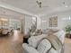 Open-concept living room with wood floors, neutral decor, and a large sectional at 630 Brashy St, Woodstock, GA 30188