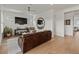 Open concept living room with hardwood floors and a comfortable leather sofa at 630 Brashy St, Woodstock, GA 30188