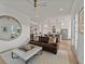 Spacious living room with a stylish ottoman, hardwood floors, and an open layout to the kitchen at 630 Brashy St, Woodstock, GA 30188