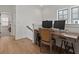 Bright office space with wood floors and a stylish desk setup, perfect for working from home at 630 Brashy St, Woodstock, GA 30188