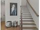 Elegant staircase with hardwood treads and a decorative horse art piece at 630 Brashy St, Woodstock, GA 30188