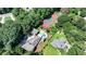 Expansive aerial view of a home with a pool, tennis court, lush landscaping, and mature trees on a large lot at 1024 Lake Charles Dr, Roswell, GA 30075