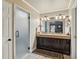Bathroom features a double sink vanity, dark wood cabinetry and a glass enclosed shower at 1024 Lake Charles Dr, Roswell, GA 30075