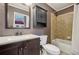 Bathroom featuring single sink vanity, mirror and tub with shower at 1024 Lake Charles Dr, Roswell, GA 30075