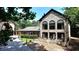 Stone-faced home with a charming patio and large windows for bright, airy interiors at 1024 Lake Charles Dr, Roswell, GA 30075