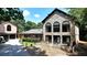 Beautiful stone home showcasing well-maintained landscaping and elegant exterior design at 1024 Lake Charles Dr, Roswell, GA 30075