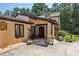 Welcoming front entrance featuring stone accents, a black front door, and beautifully landscaped surroundings at 1024 Lake Charles Dr, Roswell, GA 30075