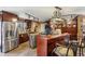 Gourmet kitchen featuring stainless steel appliances, custom cabinetry, a center island, and stone accents at 1024 Lake Charles Dr, Roswell, GA 30075