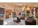 Cozy living room with a stone fireplace, skylight, plush leather seating, and eye-catching wall texture at 1024 Lake Charles Dr, Roswell, GA 30075