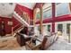 A modern open-concept living room featuring a high ceiling, and a staircase with metal railings at 1024 Lake Charles Dr, Roswell, GA 30075