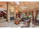 Inviting living room featuring a stone fireplace, large windows, comfortable seating, and eye-catching wall texture at 1024 Lake Charles Dr, Roswell, GA 30075
