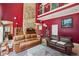A modern open-concept living room featuring a stone wall, and an open staircase with metal railings at 1024 Lake Charles Dr, Roswell, GA 30075