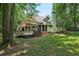 The back exterior features multiple decks, porches and views of the backyard at 105 Postwood Dr, Fayetteville, GA 30215