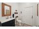 Bathroom with a unique mirror, toilet, and a white door with a wooden frame at 105 Postwood Dr, Fayetteville, GA 30215