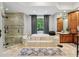 Luxurious bathroom featuring tile floors, a shower, and an elegant soaking tub at 105 Postwood Dr, Fayetteville, GA 30215