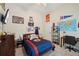 A bedroom featuring a TV, sports decor, neutral walls, and a comfortable bed at 105 Postwood Dr, Fayetteville, GA 30215