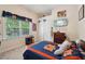 A bedroom displays sports decor, a window with blinds, and neutral walls at 105 Postwood Dr, Fayetteville, GA 30215