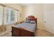 Traditional bedroom features a wooden bed frame, neutral walls, and a bright window at 105 Postwood Dr, Fayetteville, GA 30215