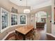 Sunny breakfast nook with large windows and hardwood floors offers a cozy dining space at 105 Postwood Dr, Fayetteville, GA 30215