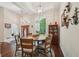 Bright dining area with high ceilings, wood floors, decorative lighting, and large windows at 105 Postwood Dr, Fayetteville, GA 30215