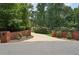 Long driveway entrance with brick design and landscaping at 105 Postwood Dr, Fayetteville, GA 30215