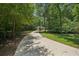 Driveway with home in background, lined with mature trees and landscape at 105 Postwood Dr, Fayetteville, GA 30215