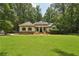 Beautiful single-story home boasts lush lawn, mature trees, and inviting curb appeal at 105 Postwood Dr, Fayetteville, GA 30215