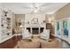 Bright living room with fireplace, built-in shelving, ceiling fan and double doors to the patio at 105 Postwood Dr, Fayetteville, GA 30215