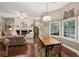 Inviting living room boasts a fireplace, a dining area, and large windows showcasing the outdoor view at 105 Postwood Dr, Fayetteville, GA 30215