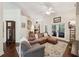 Comfortable living room featuring high ceilings, hardwood floors and cozy furniture at 105 Postwood Dr, Fayetteville, GA 30215