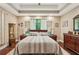 Relaxing main bedroom featuring a ceiling fan, large windows, and dark-stained hardwood floors at 105 Postwood Dr, Fayetteville, GA 30215