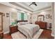 Main bedroom featuring a ceiling fan, large windows, and dark-stained hardwood floors at 105 Postwood Dr, Fayetteville, GA 30215