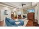 Main bedroom featuring hardwood floors, a fireplace, a ceiling fan, and private patio access at 105 Postwood Dr, Fayetteville, GA 30215