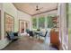 Enclosed carpeted sunroom with a dining table, and multiple windows at 105 Postwood Dr, Fayetteville, GA 30215