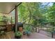 Outdoor deck with a grill, seating, and lush greenery, perfect for outdoor dining and entertaining at 1270 Taylor Oaks Dr, Roswell, GA 30076