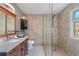 Bathroom with tiled shower, wood cabinets, granite countertops, and modern fixtures at 1270 Taylor Oaks Dr, Roswell, GA 30076