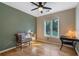 Bedroom with a ceiling fan, hardwood floors, and a bright window overlooking the yard at 1270 Taylor Oaks Dr, Roswell, GA 30076