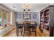Elegant dining room with hardwood floors, a stylish chandelier, and a bookshelf for storage at 1270 Taylor Oaks Dr, Roswell, GA 30076