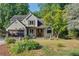 Charming two-story home with a well-manicured front yard and inviting pergola-covered entrance at 1270 Taylor Oaks Dr, Roswell, GA 30076