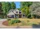 Charming two-story home with a well-manicured lawn, a pergola-covered front porch, and an attached two-car garage at 1270 Taylor Oaks Dr, Roswell, GA 30076