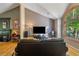 Inviting living room with a fireplace, hardwood floors, and a large window overlooking the greenery at 1270 Taylor Oaks Dr, Roswell, GA 30076