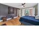 Large main bedroom with hardwood floors, neutral tones, an area rug, and multiple access doors at 1270 Taylor Oaks Dr, Roswell, GA 30076