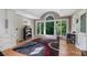 Sun-filled main bedroom with hardwood floors, built-in cabinets, stylish rug, and large windows showcasing the outdoors at 1270 Taylor Oaks Dr, Roswell, GA 30076